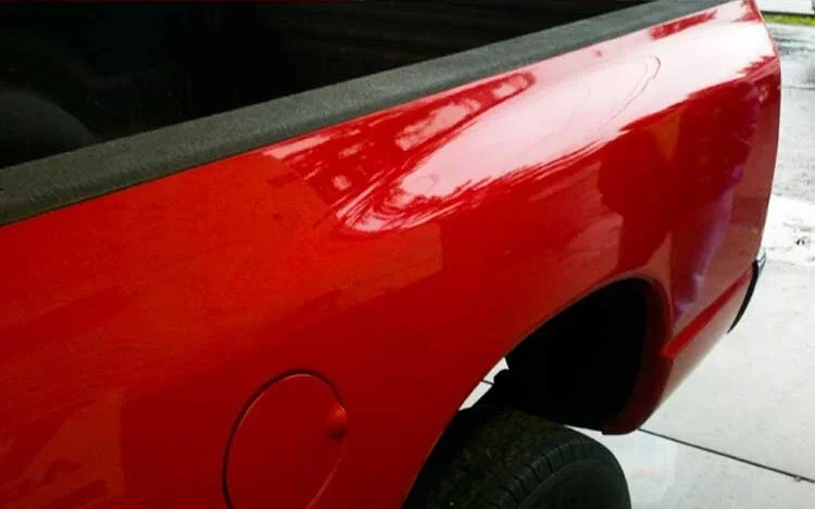 Car panel after paintless dent repair, dent fully removed